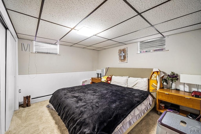 67 Macarthur Rd, Pueblo, CO 81001 - carpeted bedroom featuring a paneled ceiling and a baseboard heating unit