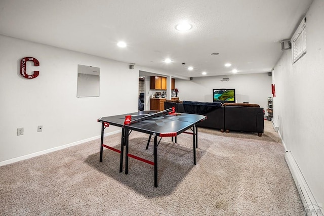 67 Macarthur Rd, Pueblo, CO 81001 - recreation room with light colored carpet, recessed lighting, and a baseboard heating unit