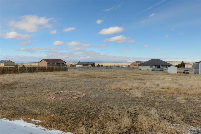 view of yard featuring a shed and fence