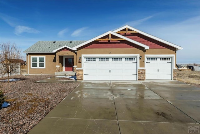 craftsman-style house with stone siding, concrete driveway, a garage, and stucco siding