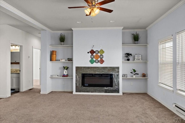 unfurnished living room featuring ornamental molding, a baseboard radiator, carpet flooring, and a high end fireplace