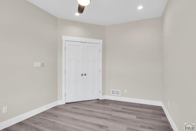 spare room with ceiling fan, recessed lighting, visible vents, light wood-style floors, and baseboards