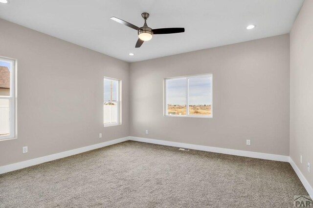 empty room featuring recessed lighting, carpet flooring, a ceiling fan, and baseboards