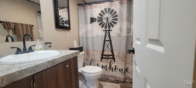 bathroom featuring toilet and vanity