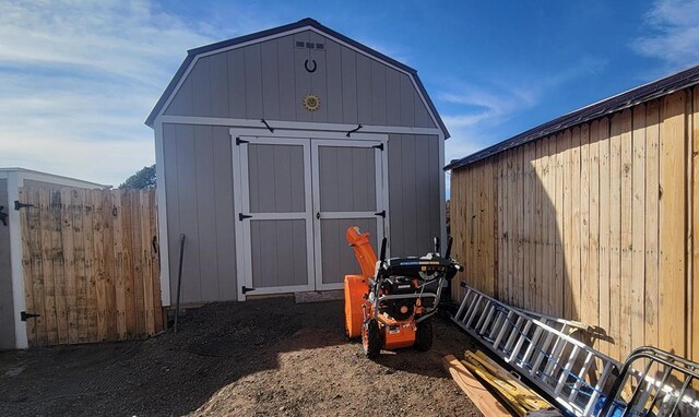 view of shed featuring fence