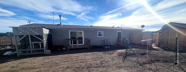 back of house featuring fence