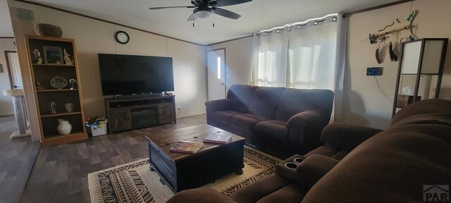 living area with lofted ceiling, ceiling fan, dark wood-style floors, and crown molding