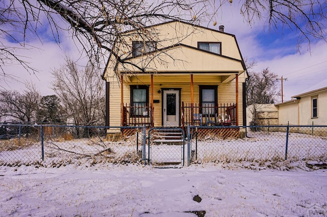 view of front of house featuring a porch, a fenced front yard, and a gate