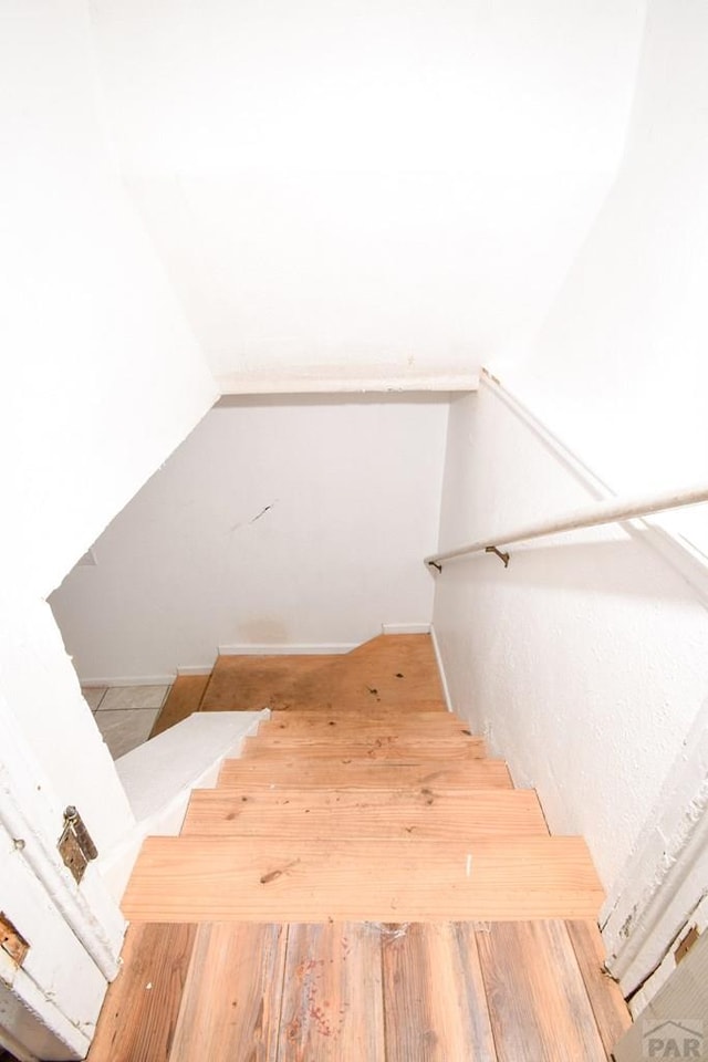 1142 Elm St, Pueblo, CO 81004 - stairs with lofted ceiling and wood finished floors