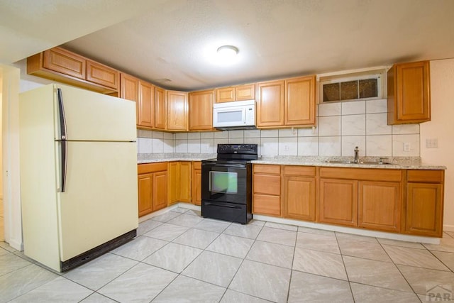 1142 Elm St, Pueblo, CO 81004 - kitchen featuring white appliances, tasteful backsplash, and light stone counters
