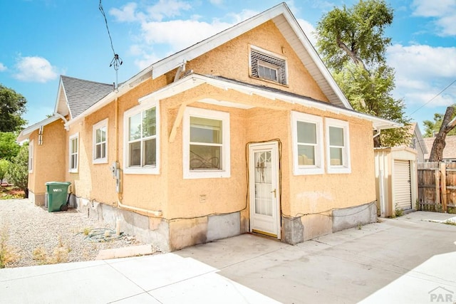 1142 Elm St, Pueblo, CO 81004 - bungalow-style house featuring stucco siding, a patio, and a shingled roof