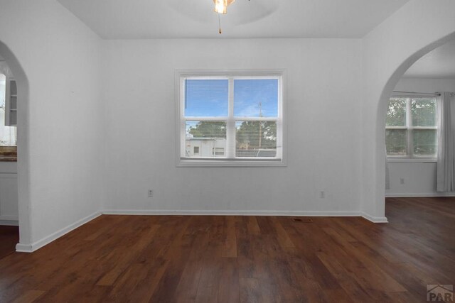 1142 Elm St, Pueblo, CO 81004 - spare room with arched walkways, wood finished floors, and a ceiling fan