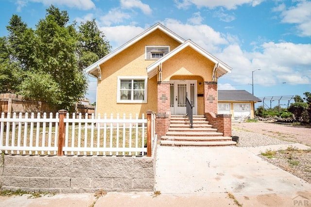 1142 Elm St, Pueblo, CO 81004 - bungalow featuring stucco siding and driveway