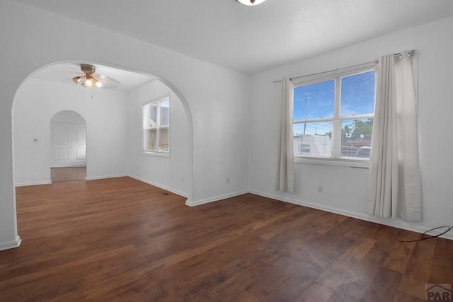 1142 Elm St, Pueblo, CO 81004 - spare room with arched walkways, ceiling fan, and wood finished floors
