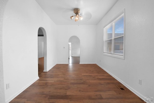 1142 Elm St, Pueblo, CO 81004 - unfurnished dining area with arched walkways, a ceiling fan, and wood finished floors