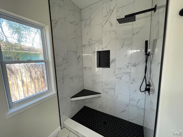 bathroom with a marble finish shower