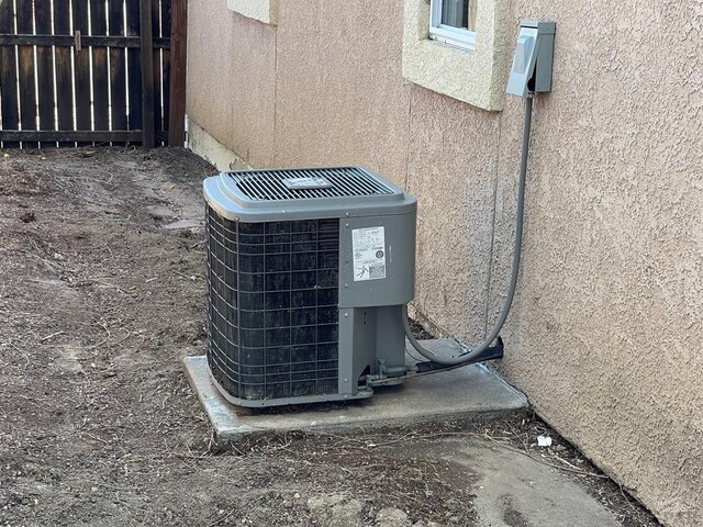 exterior details with central air condition unit and stucco siding