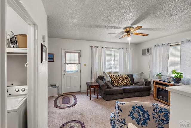 2306 Cortez Rd, Pueblo, CO 81003 - carpeted living room featuring washer / clothes dryer, a wall mounted air conditioner, ceiling fan, and a textured ceiling