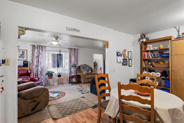 dining space featuring a ceiling fan and wood finished floors