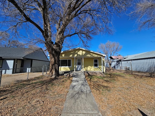 bungalow-style house with fence