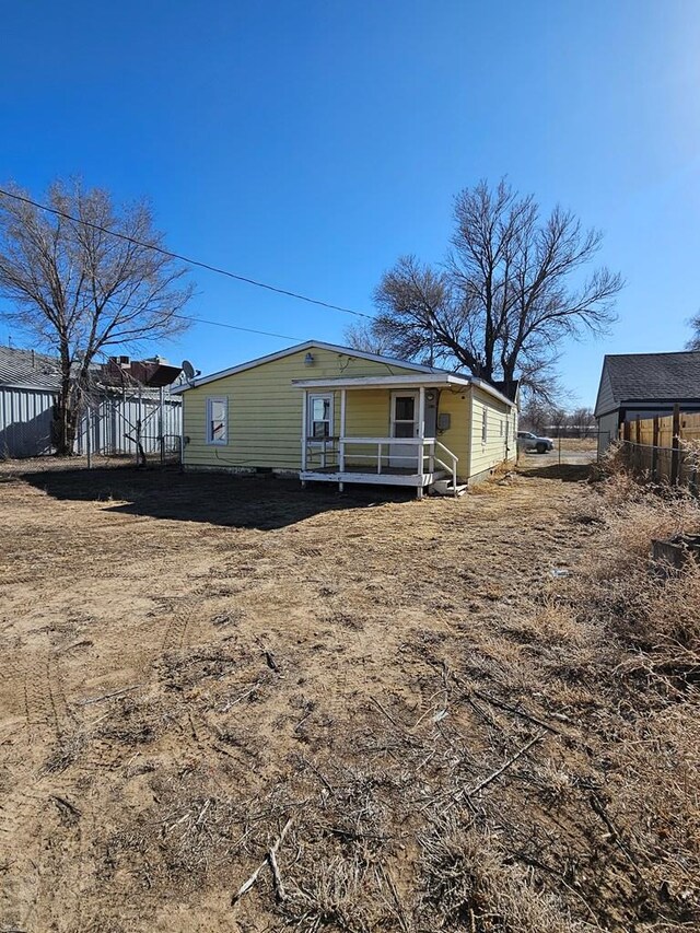 rear view of house with fence