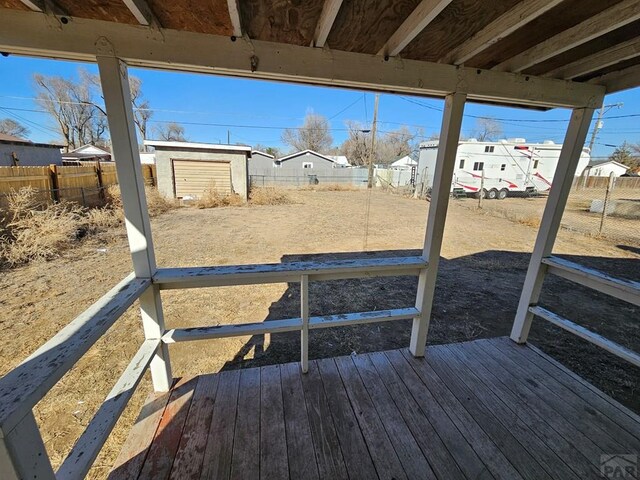 wooden deck featuring a residential view and a fenced backyard