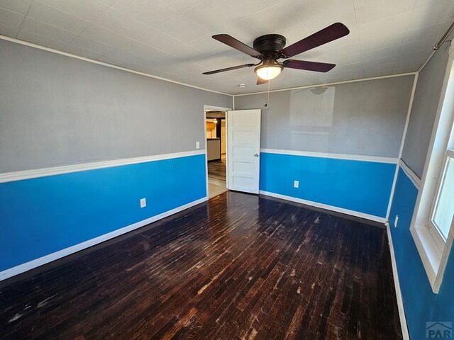 unfurnished room with ceiling fan, baseboards, and wood finished floors