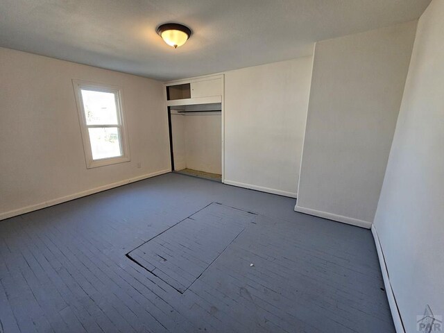 unfurnished bedroom featuring a closet and baseboards