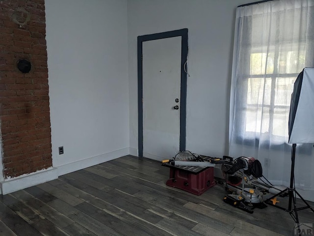 empty room featuring dark wood finished floors and baseboards