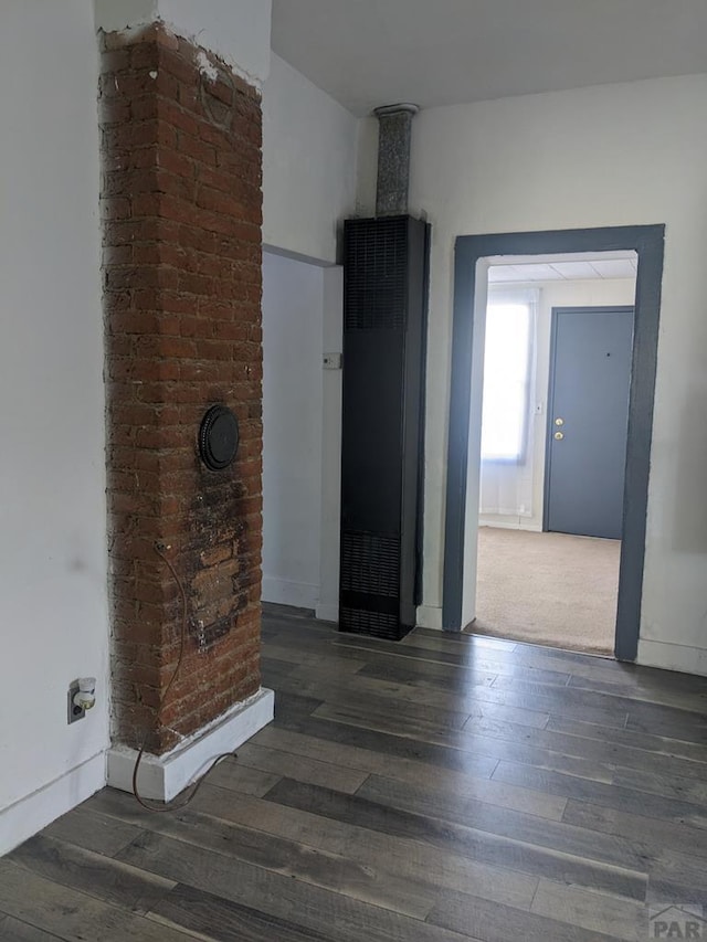 empty room featuring dark wood finished floors and baseboards