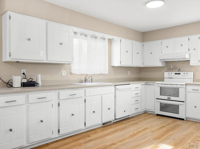 760 Crystal Ln, Pueblo, CO 81006 - kitchen with under cabinet range hood, white appliances, a sink, white cabinets, and light countertops