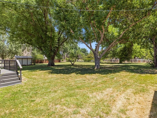 760 Crystal Ln, Pueblo, CO 81006 - view of yard featuring a fenced backyard, an outbuilding, a deck, and a shed
