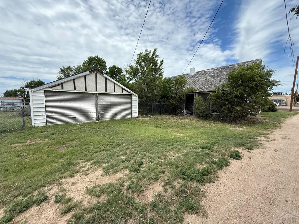 309 W 13th St, Eads, CO 81036 - view of yard featuring an outdoor structure and a garage