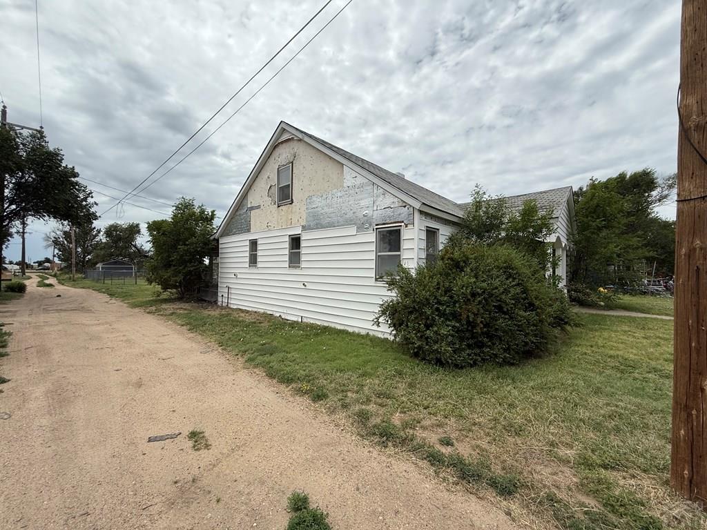 309 W 13th St, Eads, CO 81036 - view of property exterior with a yard