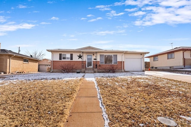 ranch-style home with a garage, concrete driveway, and brick siding