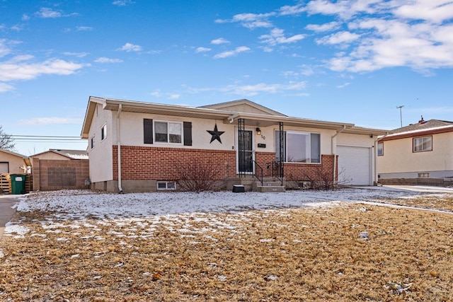 single story home with brick siding and an attached garage