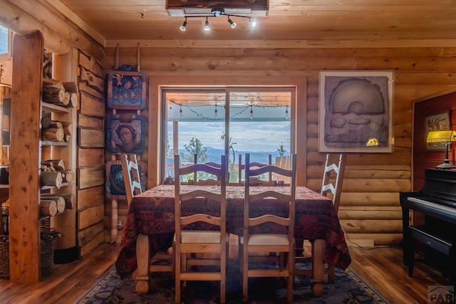 361 Crystal Peak Rd, Florissant, CO 80814 - dining room featuring rustic walls, rail lighting, wood ceiling, and wood finished floors
