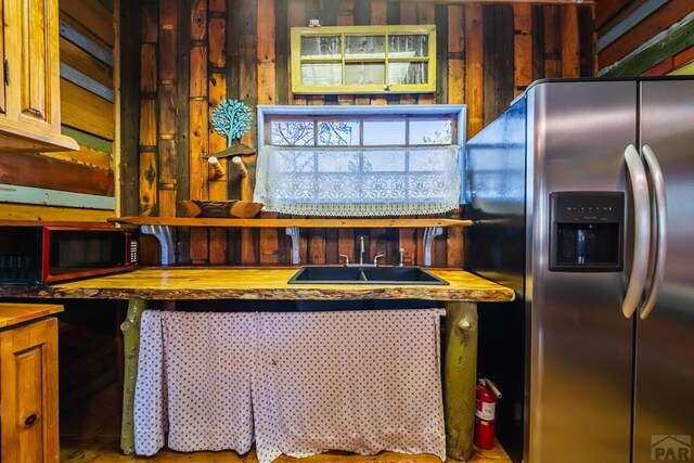 361 Crystal Peak Rd, Florissant, CO 80814 - kitchen with butcher block countertops, stainless steel refrigerator with ice dispenser, and a sink