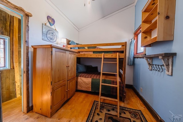 361 Crystal Peak Rd, Florissant, CO 80814 - bedroom featuring lofted ceiling, light wood finished floors, baseboards, and crown molding