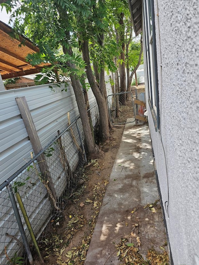 view of property exterior featuring fence and stucco siding