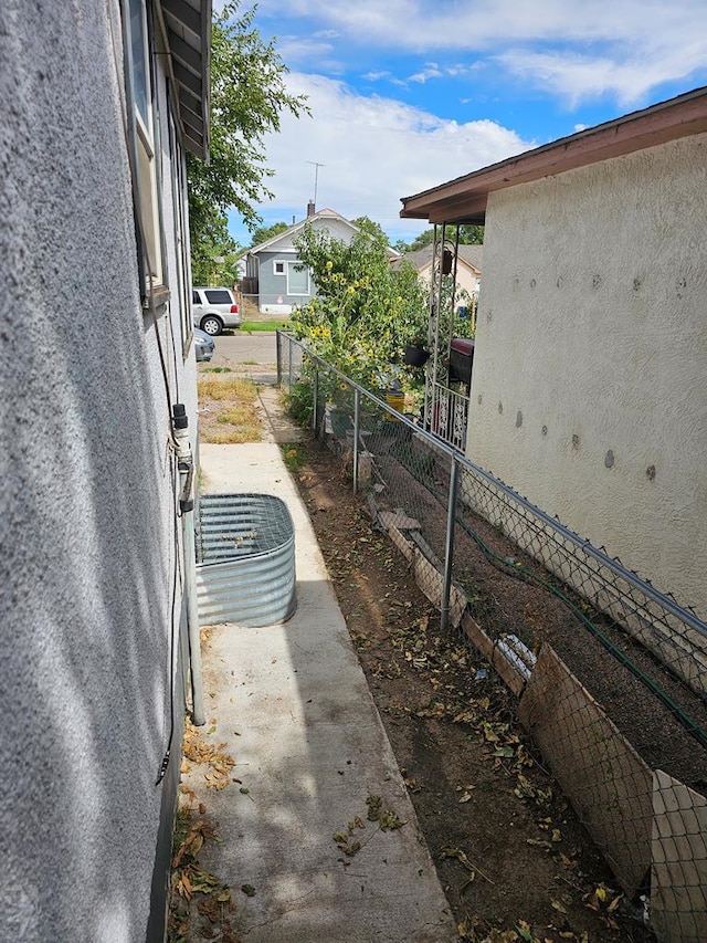 view of property exterior featuring fence and stucco siding