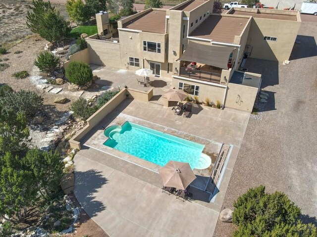 view of swimming pool with a fenced in pool and a patio