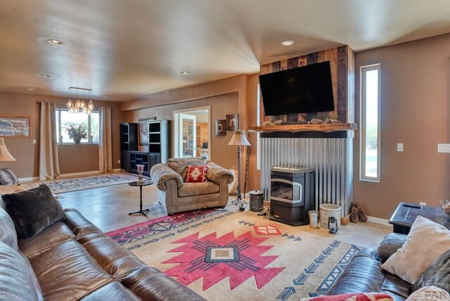 living room featuring a wood stove, baseboards, and recessed lighting