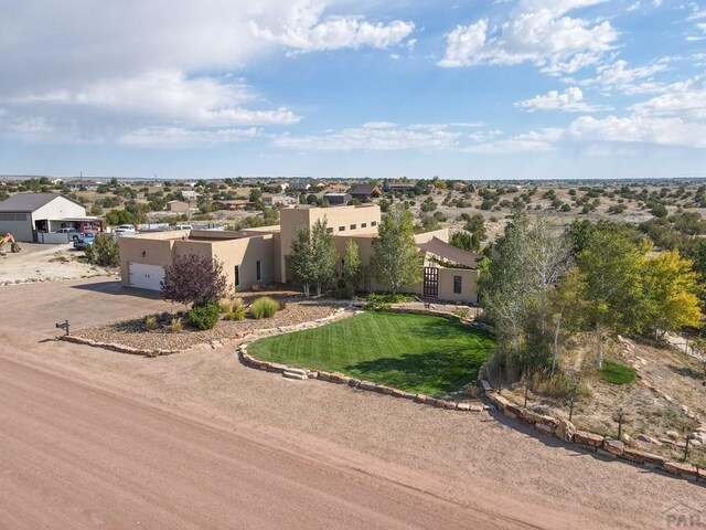 view of front of home featuring concrete driveway, an attached garage, a residential view, and stucco siding