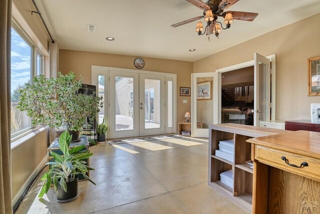 foyer with concrete flooring, ceiling fan, french doors, and recessed lighting