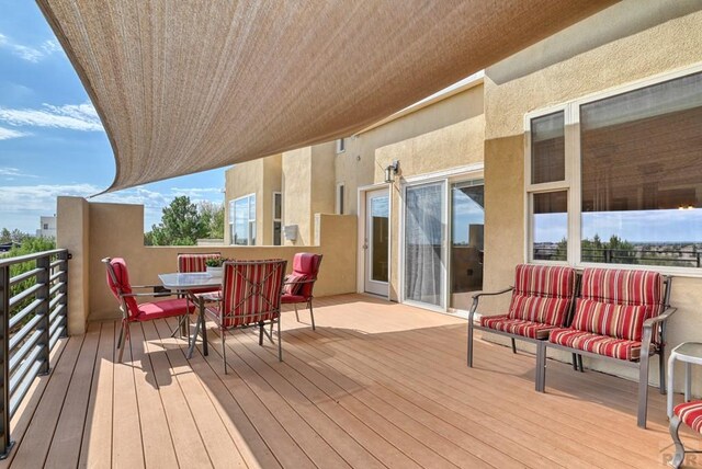 wooden terrace with outdoor dining area