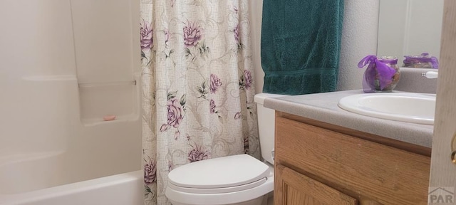 bathroom with shower / bath combination with curtain, vanity, and toilet