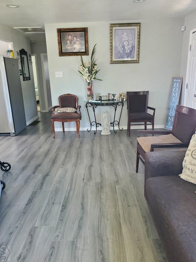 interior space featuring light wood-style flooring and baseboards