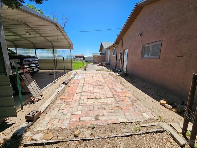 103 S Goff St, Eads, CO 81036 - view of patio / terrace with a gate, a carport, and fence