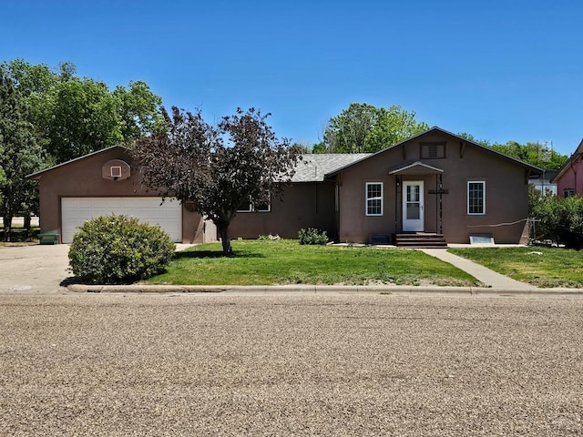 103 S Goff St, Eads, CO 81036 - single story home with stucco siding, a garage, a front yard, and concrete driveway